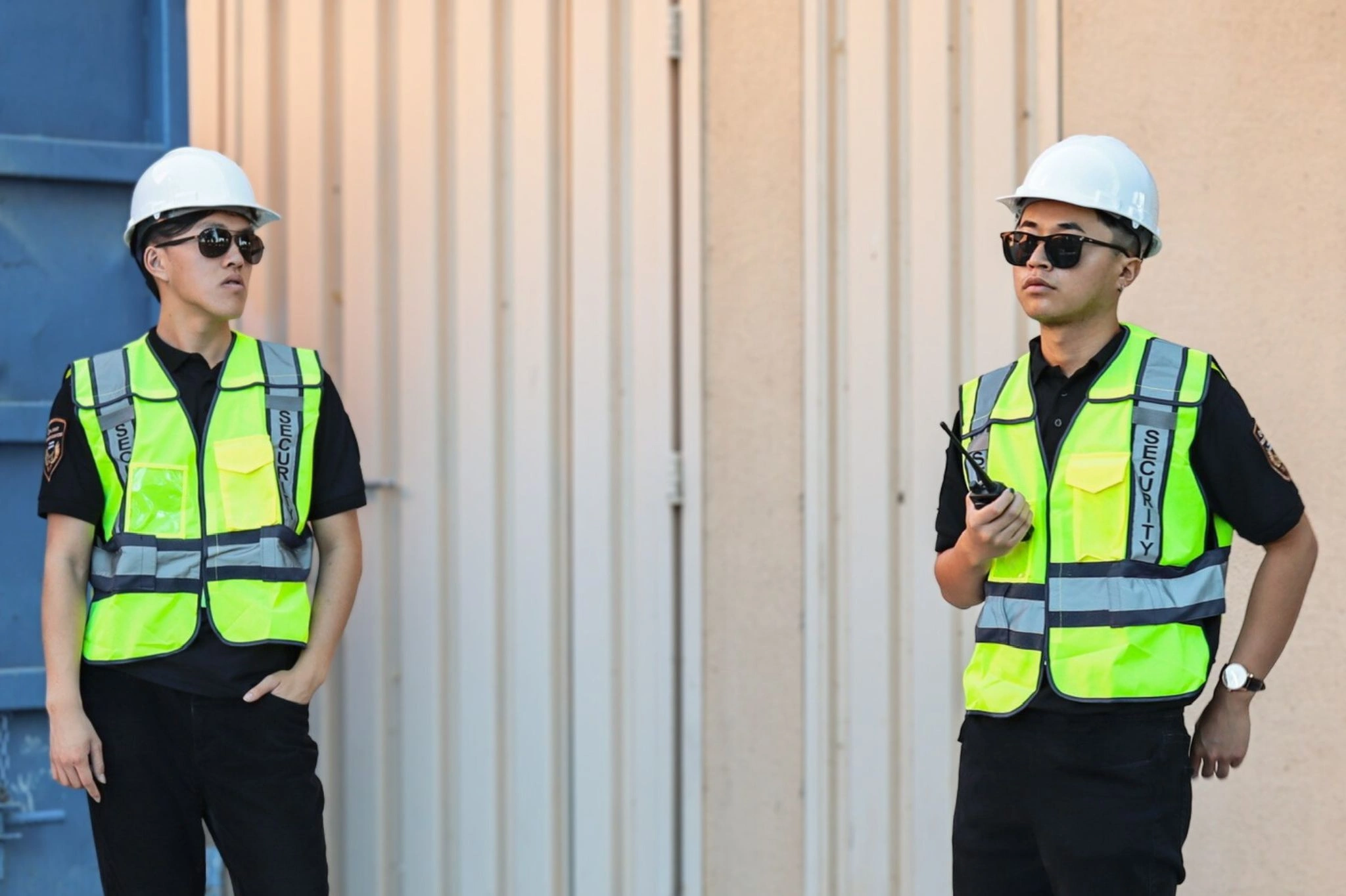 security guards wearing reflective vest and construction helmet