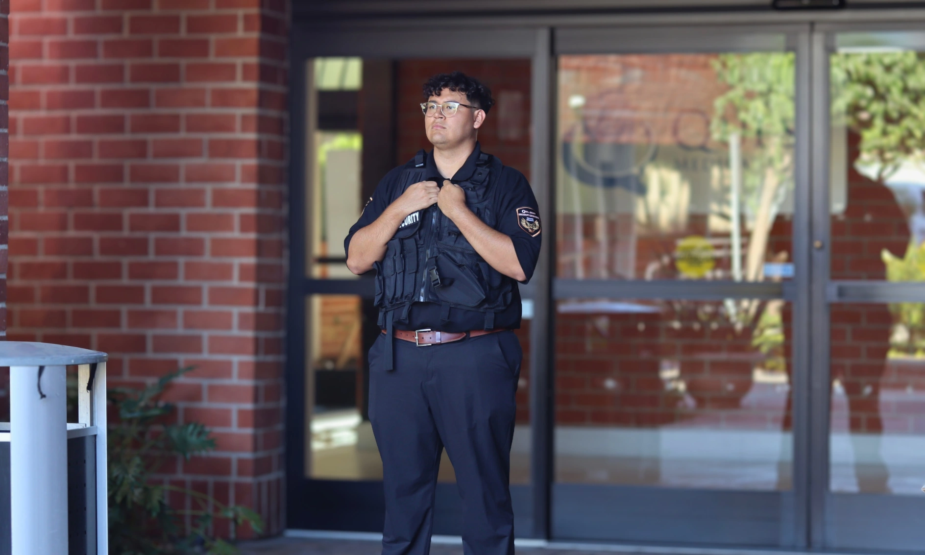 hospital security guard standing at the entrance wearing security vest