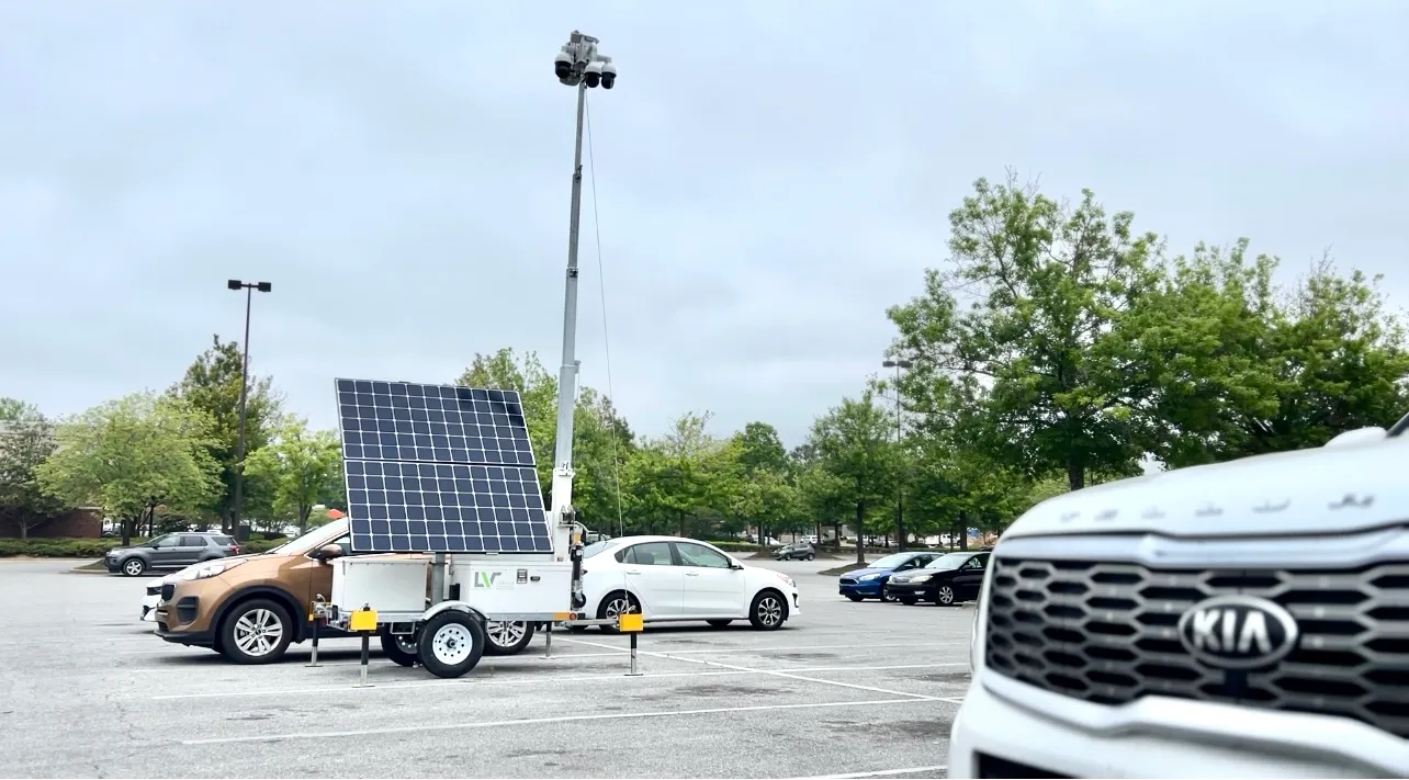 smart surveillance tower in a parking lot with cars