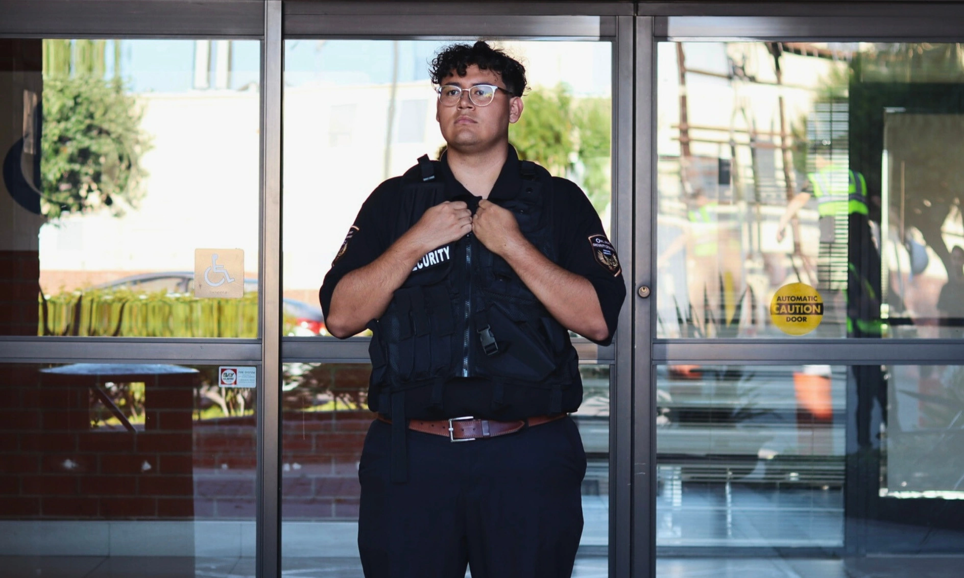 vested production security guard standing at the entrance of a production site
